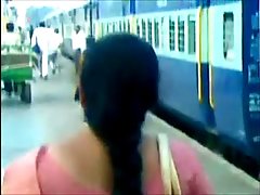 Woman with a very long hair is posing in front of the camera without clothes